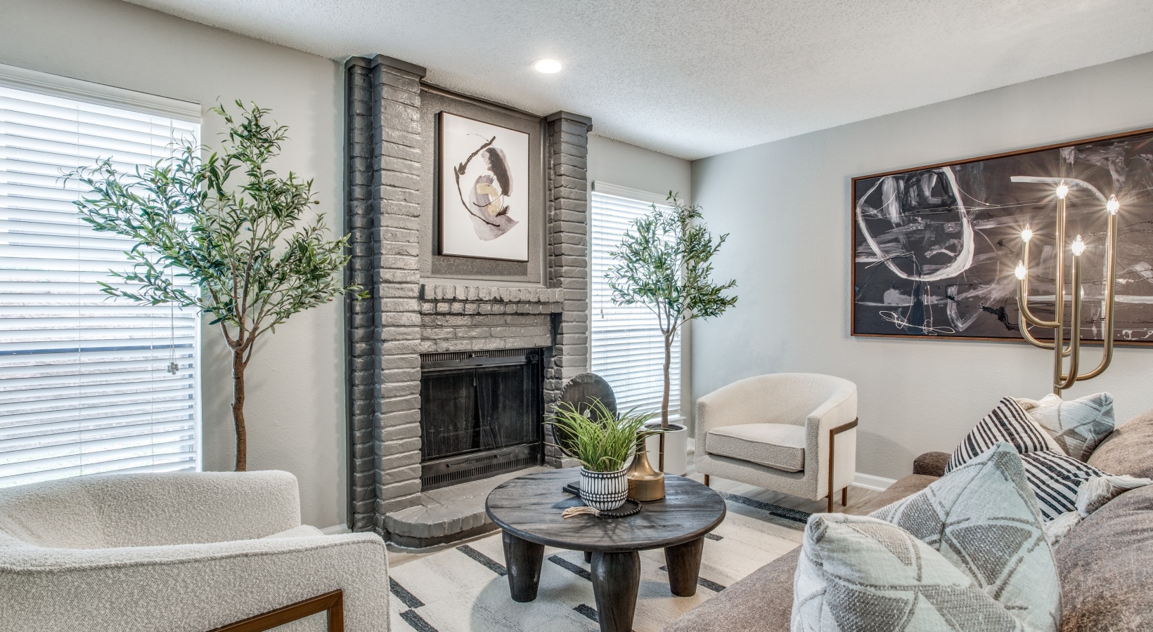 a living room with a fireplace and a couch at The Evaline