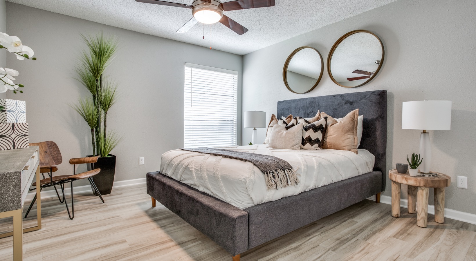 a bedroom with a bed, dresser and mirror at The Evaline