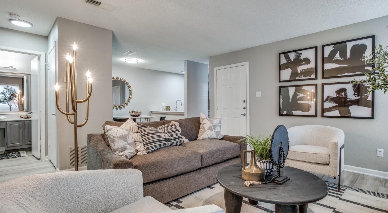 the living room has a couch, coffee table, and a television at The Evaline