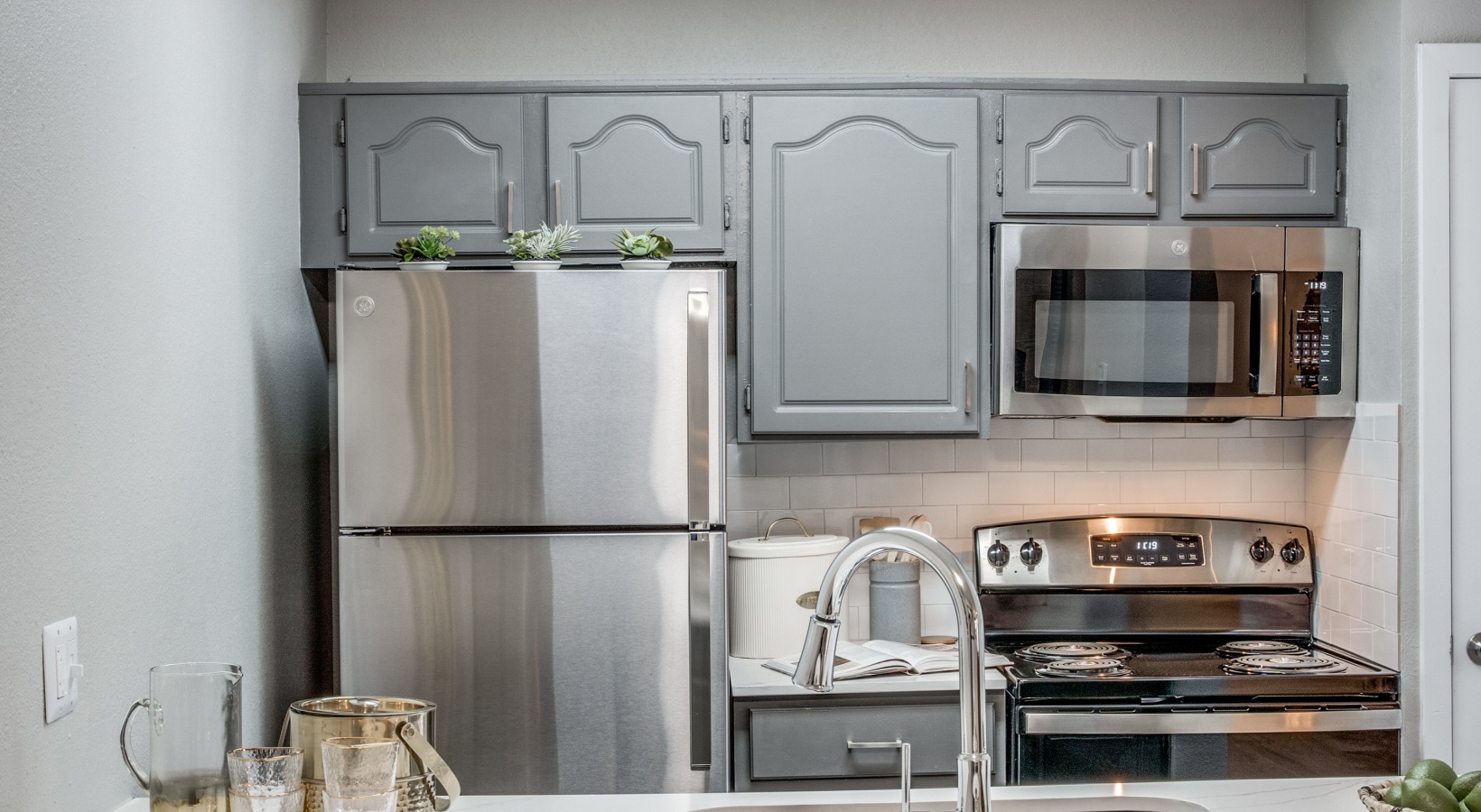 kitchen with stainless steel appliances and silver cabinets at The Evaline
