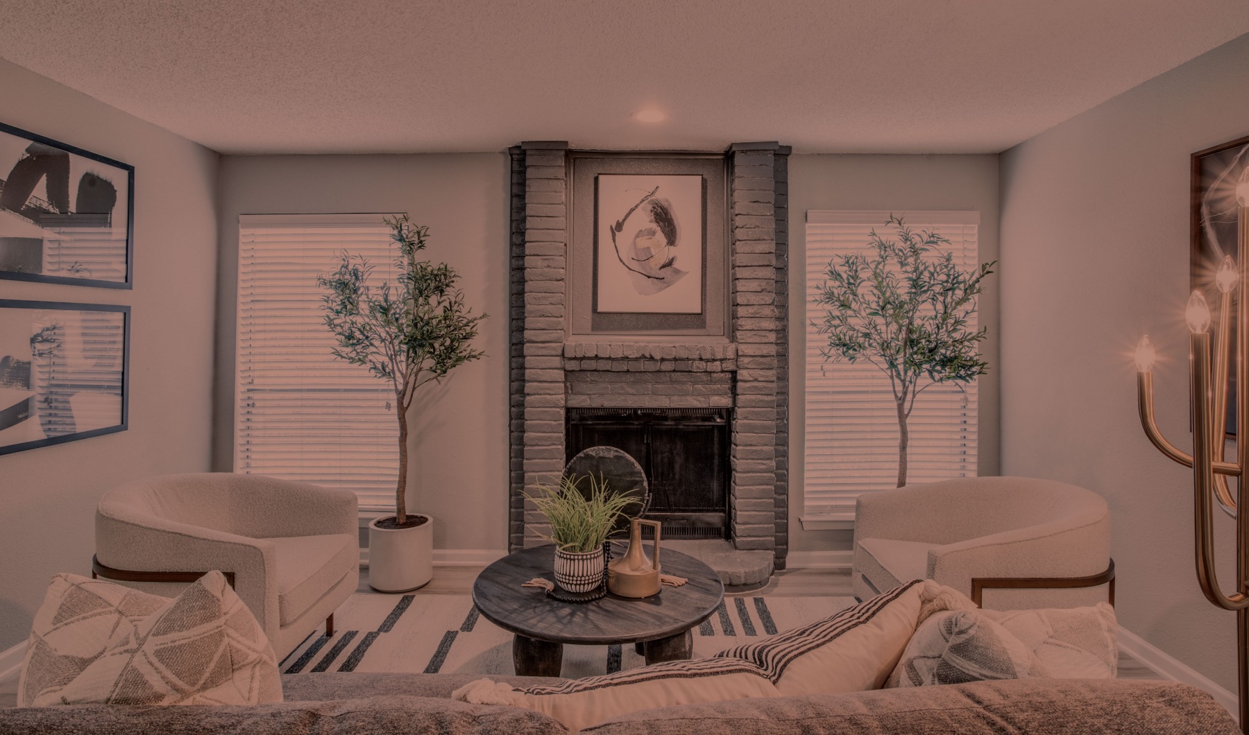 a living room with a fireplace and a couch at The Evaline