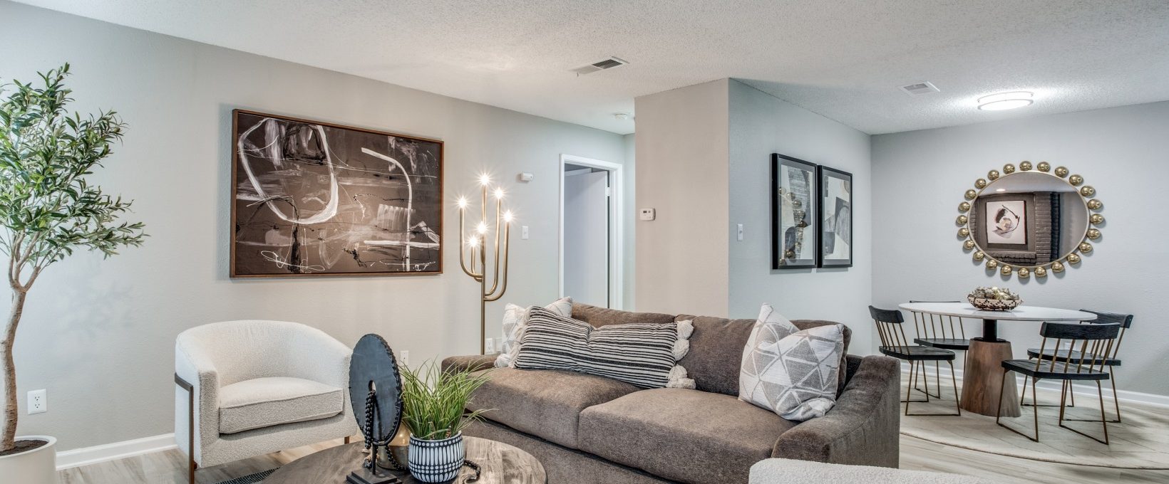 the living room has a couch, coffee table and a television at The Evaline