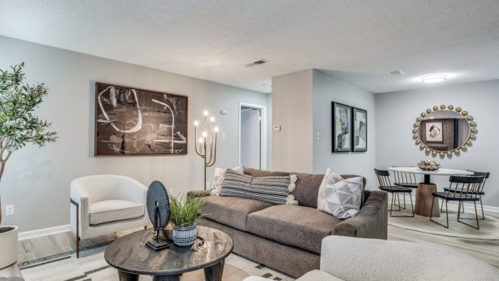 the living room has a couch, coffee table and a television at The Evaline