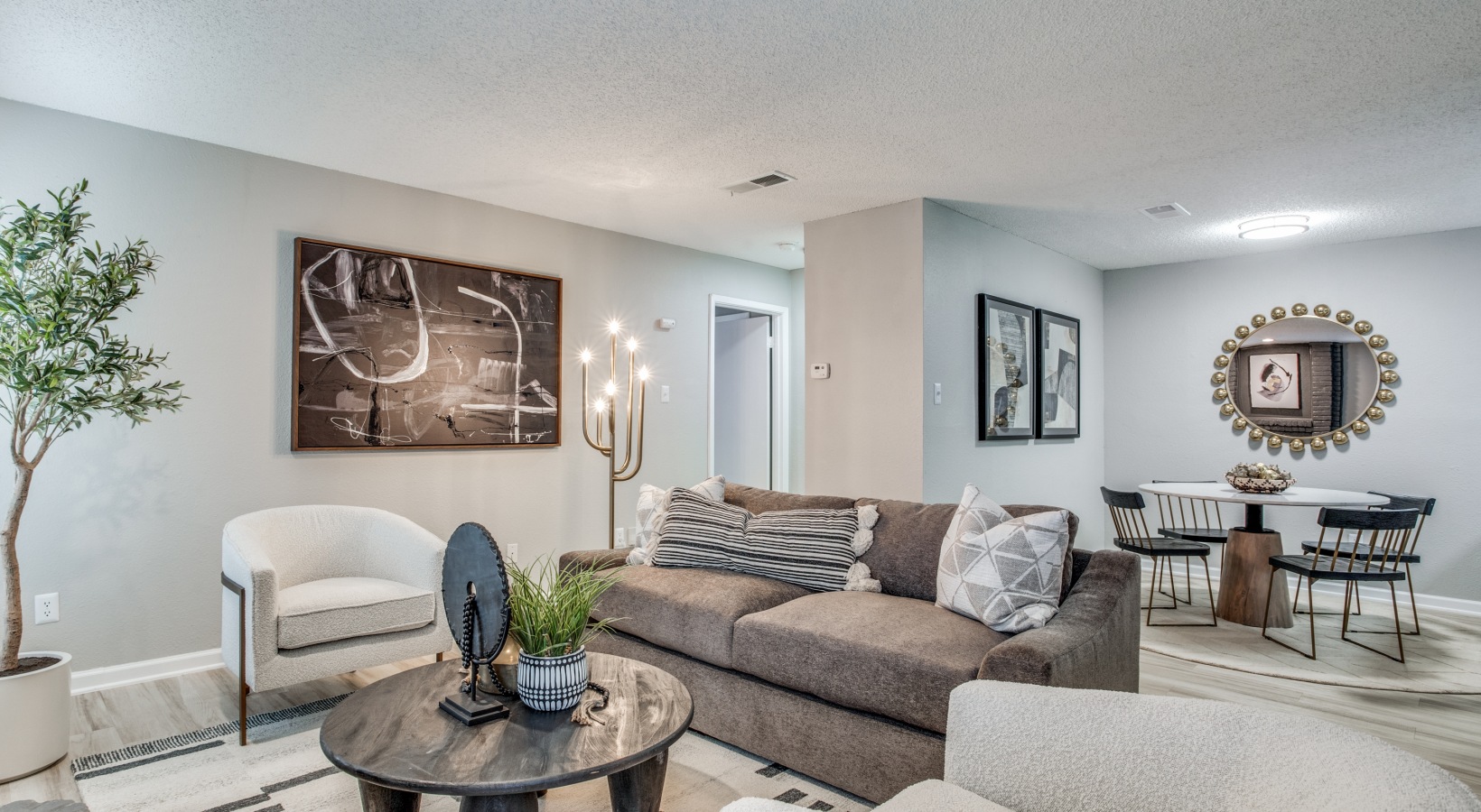the living room has a couch, coffee table and a television at The Evaline